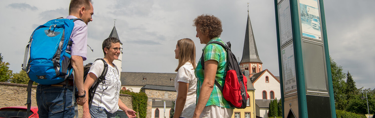 Wanderer an Haltestelle des Eifelsteig-Wanderbus